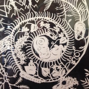 Close-up of cut paper work under glass by Marcy Miranda Janes 