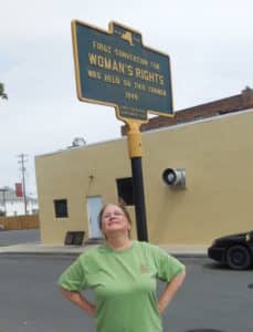 Women's Legacy Project Director, Nancy Hill, at Seneca Falls in 2014. Historic Marker.
