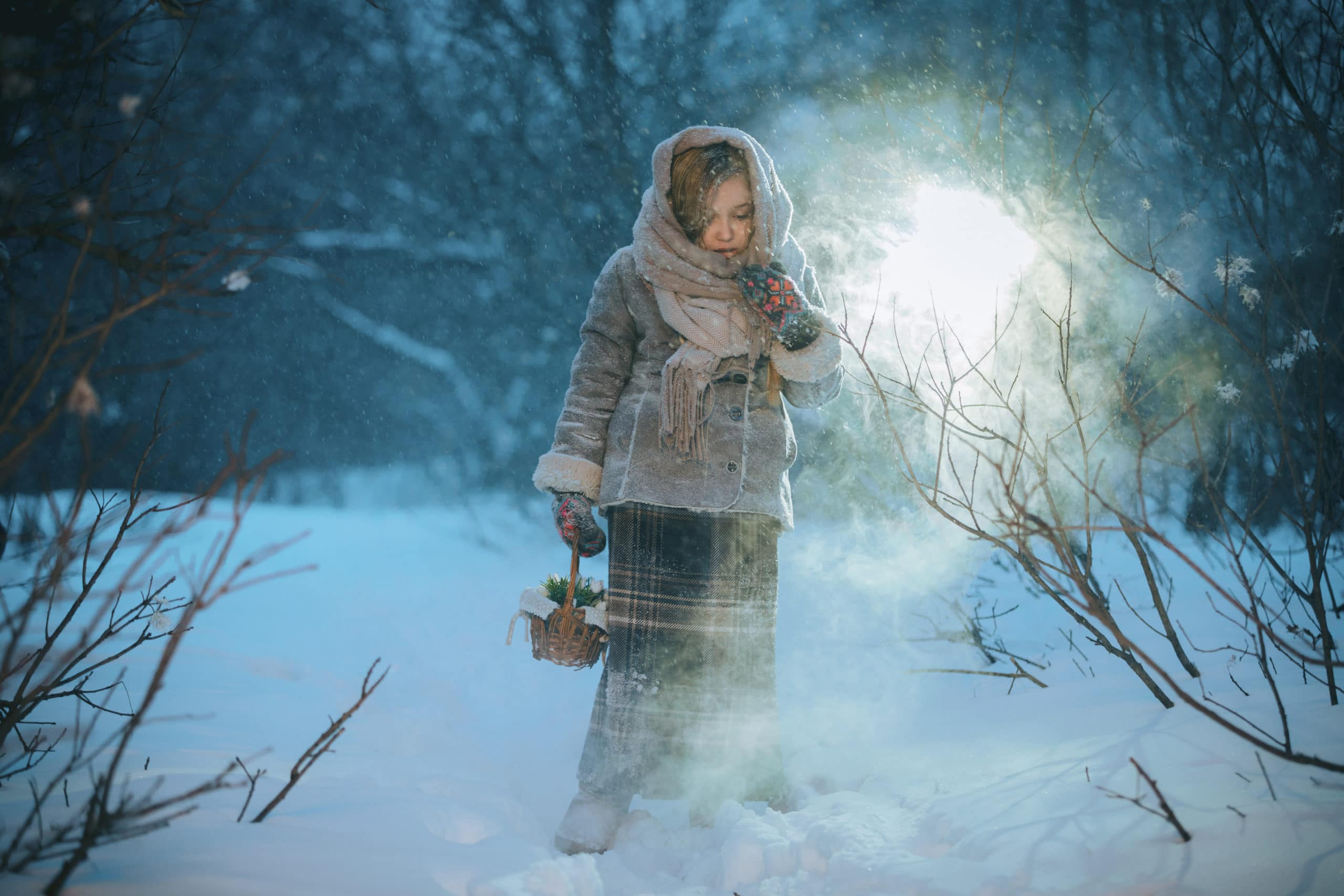 little girl with basket alone in forest in winter