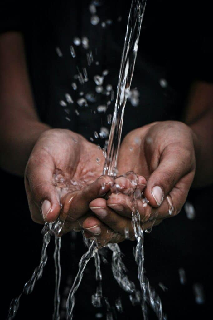 photo of water running over hands. Photo by mrjn Photography on Unsplash
