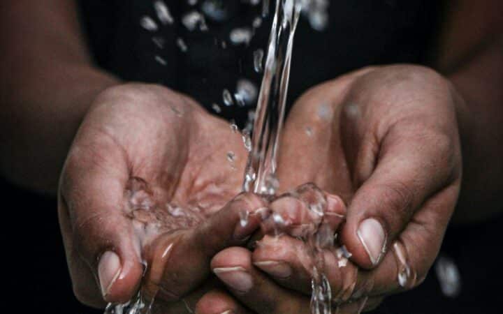 photo of water running over hands. Photo by mrjn Photography on Unsplash