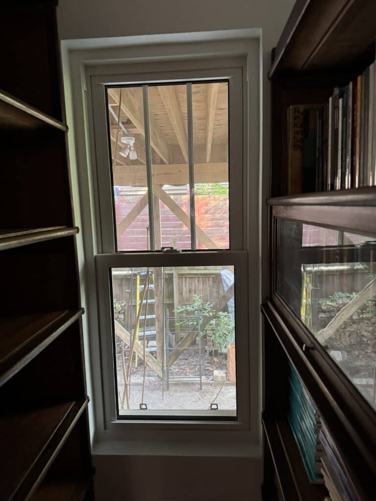 One small section of Myrdene's library showing the gorgeous wood shelves she gleans from her exentive trade network still being filled with her materials. It feels rich.